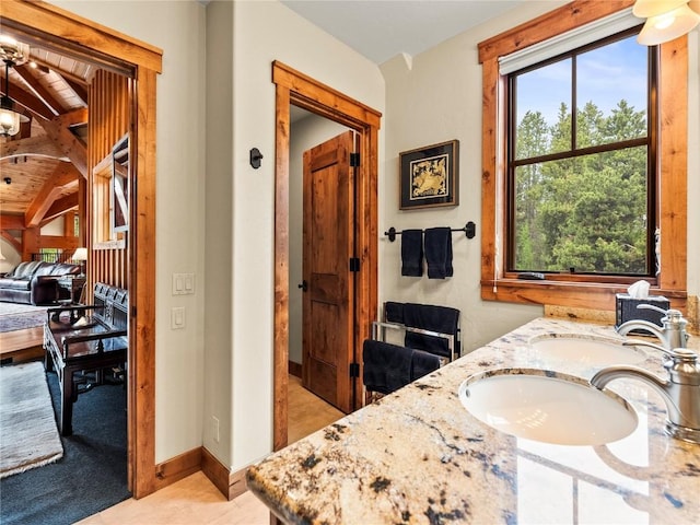 bathroom with vanity and lofted ceiling