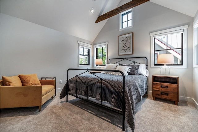 carpeted bedroom with beam ceiling and high vaulted ceiling