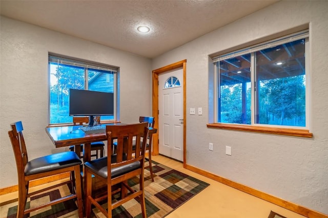 dining area with a textured ceiling