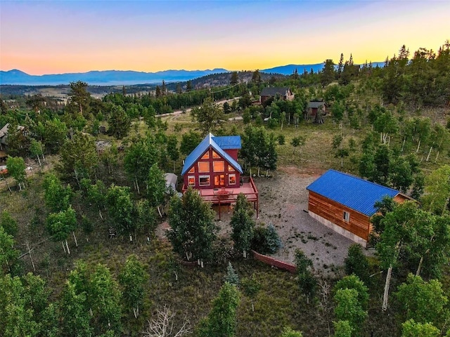 aerial view at dusk featuring a mountain view