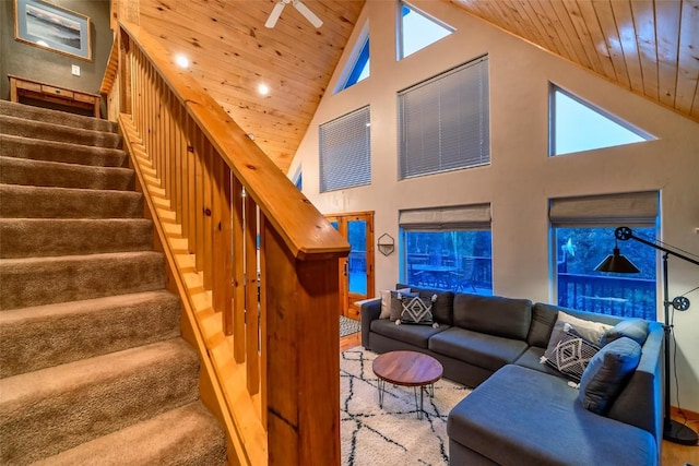 carpeted living room featuring a wealth of natural light, ceiling fan, high vaulted ceiling, and wooden ceiling