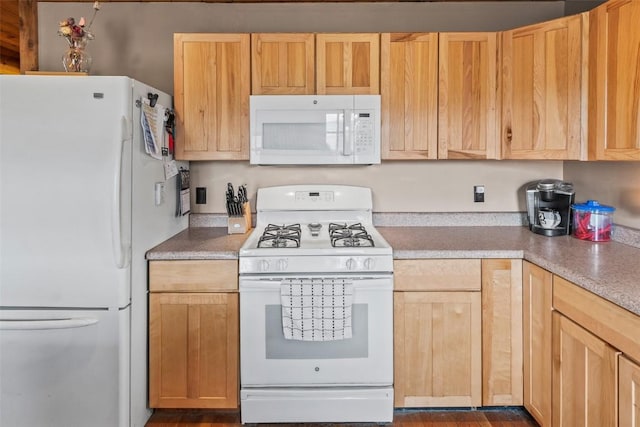 kitchen with light brown cabinetry and white appliances