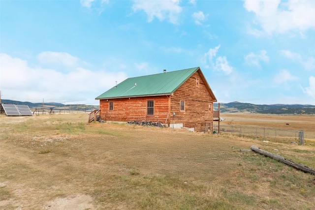 view of property exterior with a rural view