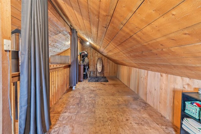 interior space with wood ceiling, wooden walls, and vaulted ceiling