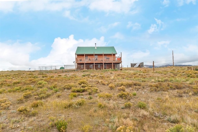 rear view of property featuring a rural view and a deck