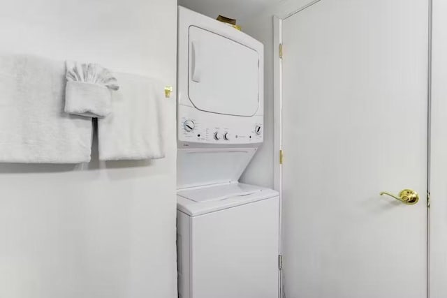 laundry area with stacked washing maching and dryer