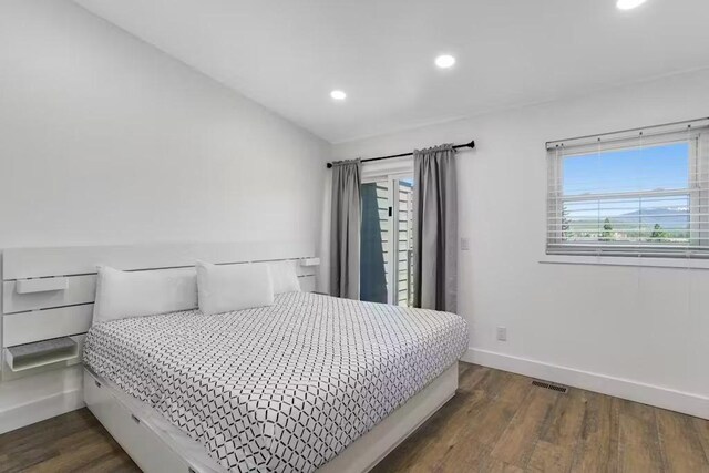 bedroom with dark hardwood / wood-style flooring