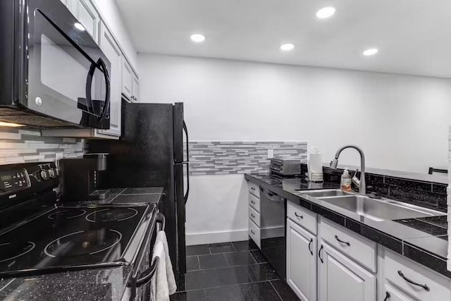 kitchen featuring tasteful backsplash, dark tile patterned floors, sink, black appliances, and white cabinets