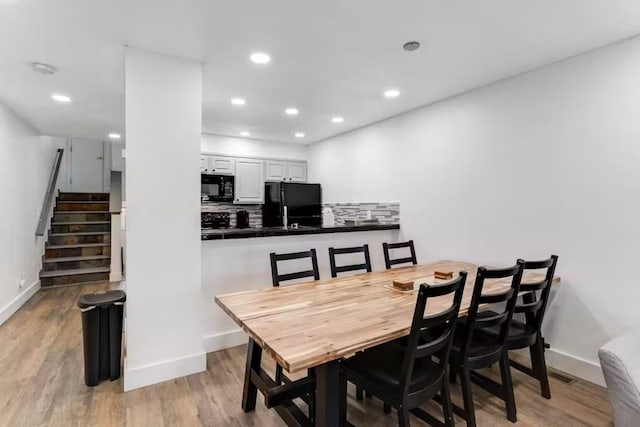 dining space with light hardwood / wood-style floors