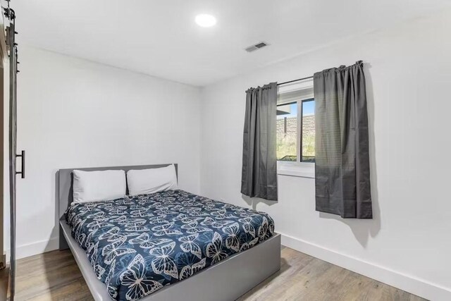 bedroom featuring hardwood / wood-style floors