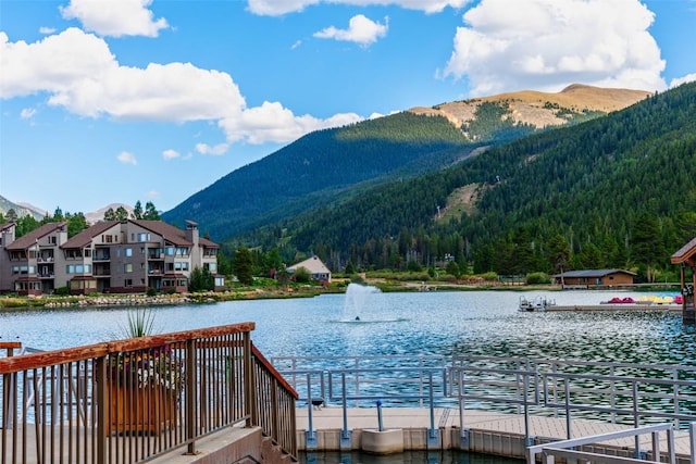 view of dock with a water and mountain view