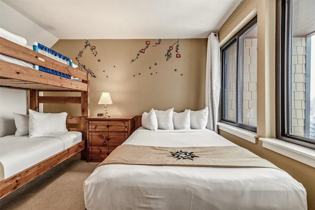 carpeted bedroom featuring vaulted ceiling