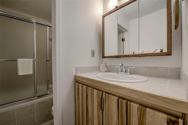 bathroom with vanity and a textured ceiling