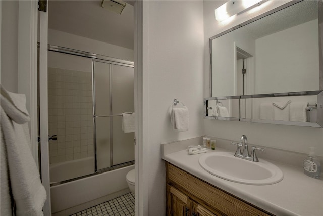 full bathroom with tile patterned flooring, vanity, enclosed tub / shower combo, and toilet