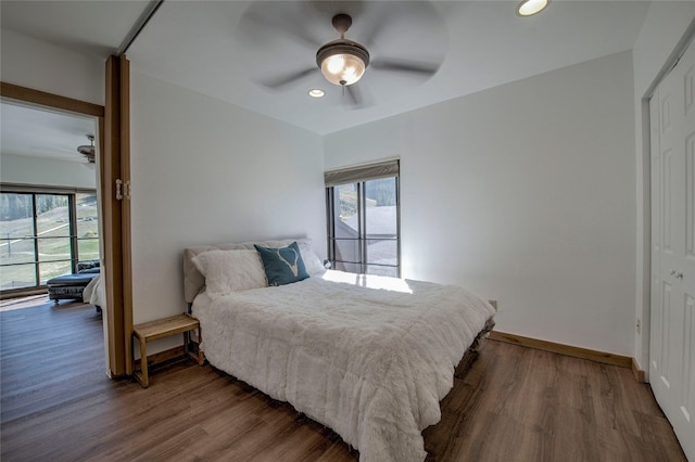 bedroom featuring hardwood / wood-style floors, ceiling fan, and a closet