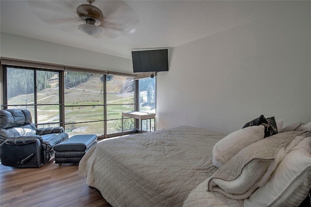 bedroom with hardwood / wood-style floors and ceiling fan