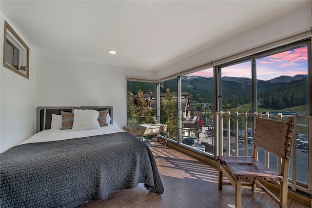 bedroom featuring a mountain view and hardwood / wood-style floors