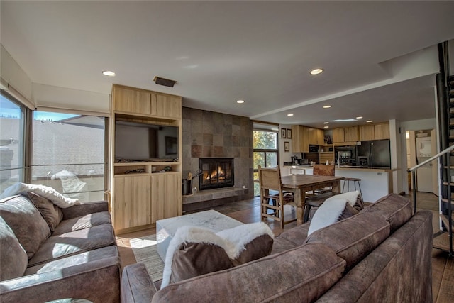 living room featuring a tile fireplace