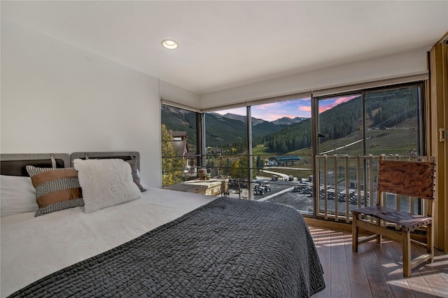 bedroom featuring hardwood / wood-style flooring and a mountain view