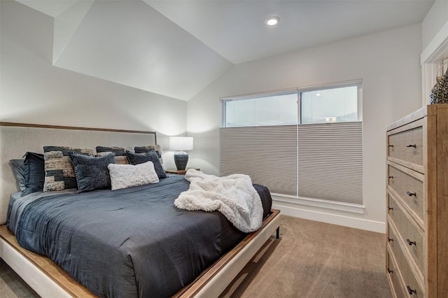 bedroom with carpet floors and lofted ceiling