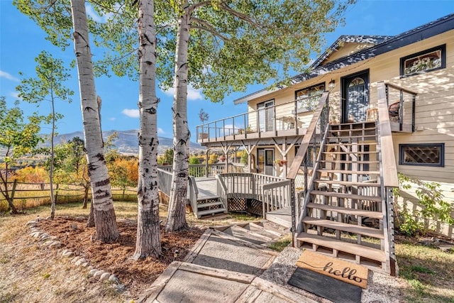 exterior space featuring stairs, fence, and a mountain view