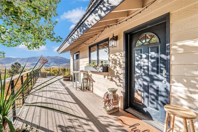 wooden terrace featuring a mountain view