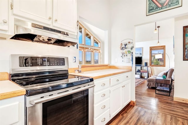 kitchen featuring under cabinet range hood, wood finished floors, white cabinetry, stainless steel electric range, and light countertops