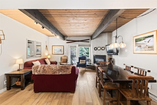 living room with beamed ceiling, wooden ceiling, track lighting, and light wood-type flooring