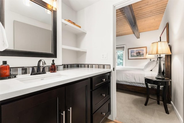 bathroom with beam ceiling, vanity, and wooden ceiling