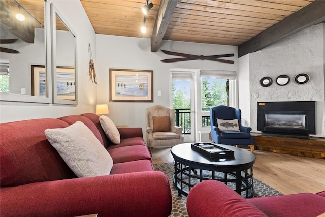 living room featuring vaulted ceiling with beams, hardwood / wood-style floors, rail lighting, and wooden ceiling