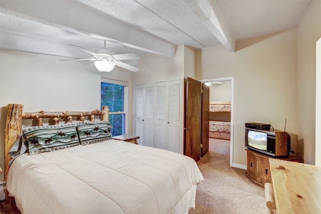 carpeted bedroom featuring beam ceiling, a textured ceiling, a closet, and ceiling fan