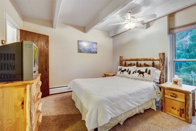 carpeted bedroom with ceiling fan, beam ceiling, and a baseboard radiator