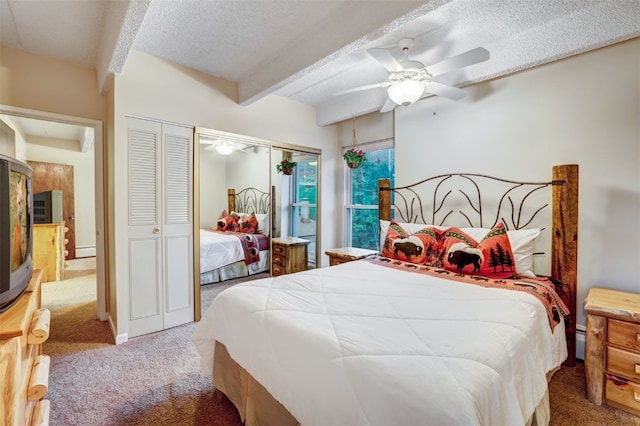 bedroom with carpet flooring, ceiling fan, beam ceiling, and a textured ceiling