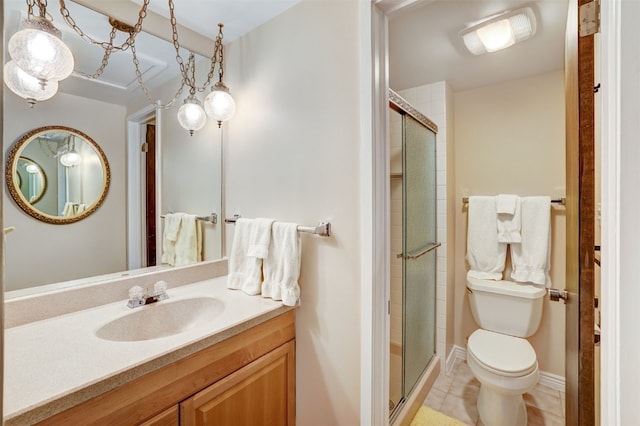 bathroom featuring toilet, vanity, tile patterned floors, and an enclosed shower