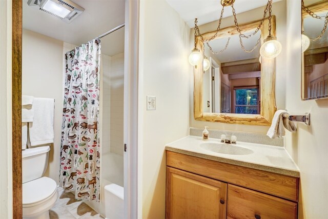 full bathroom with vanity, shower / tub combo, and toilet