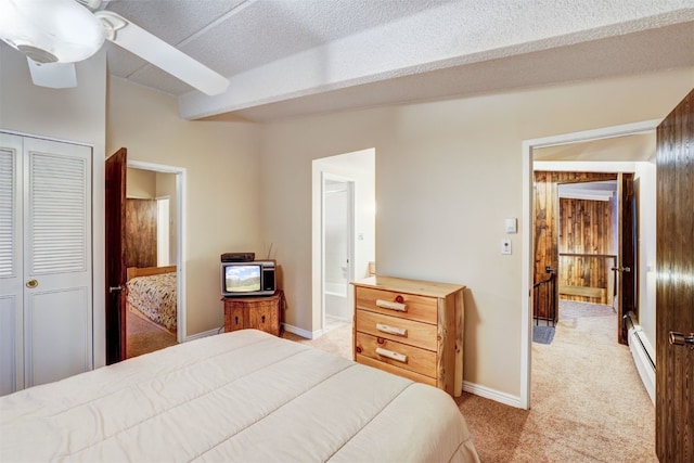 carpeted bedroom featuring ceiling fan, lofted ceiling with beams, a baseboard heating unit, a textured ceiling, and a closet