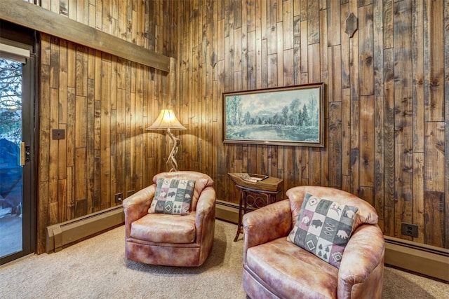 living area with wood walls, carpet floors, and baseboard heating