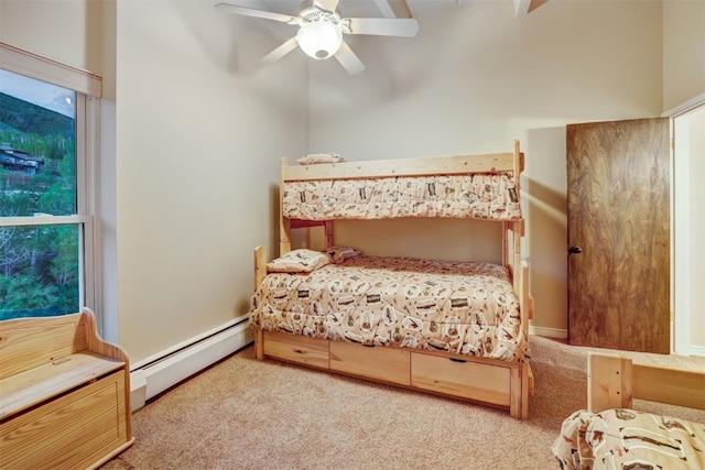 carpeted bedroom with baseboard heating and ceiling fan