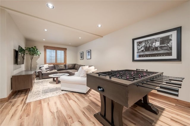 game room with light hardwood / wood-style flooring