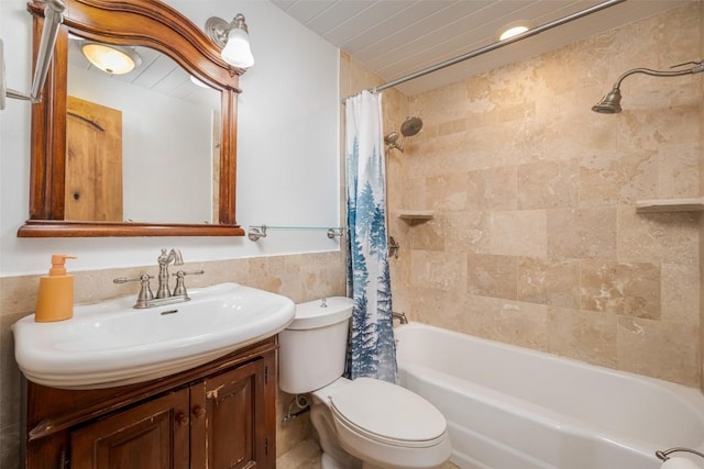 full bathroom with shower / tub combo with curtain, vanity, tile walls, and toilet