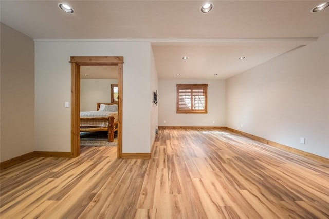 empty room with light hardwood / wood-style flooring