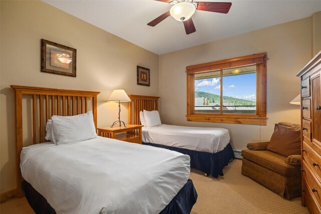 bedroom featuring light colored carpet and ceiling fan