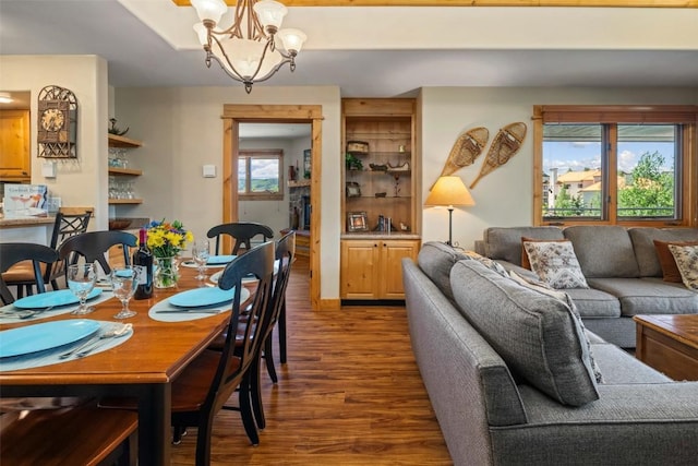 dining area with wood-type flooring and a chandelier