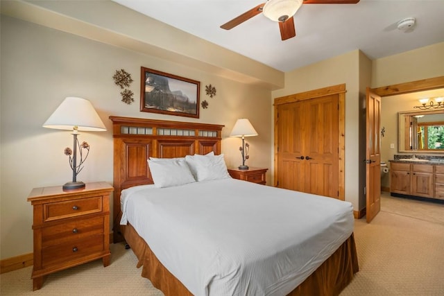 carpeted bedroom featuring sink, ceiling fan, and connected bathroom