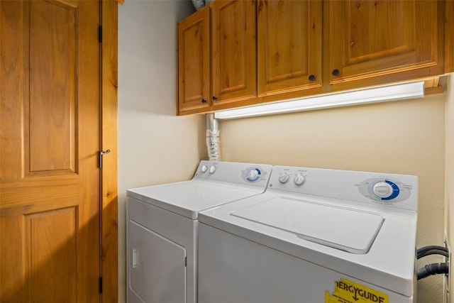 laundry area with cabinets and washing machine and clothes dryer