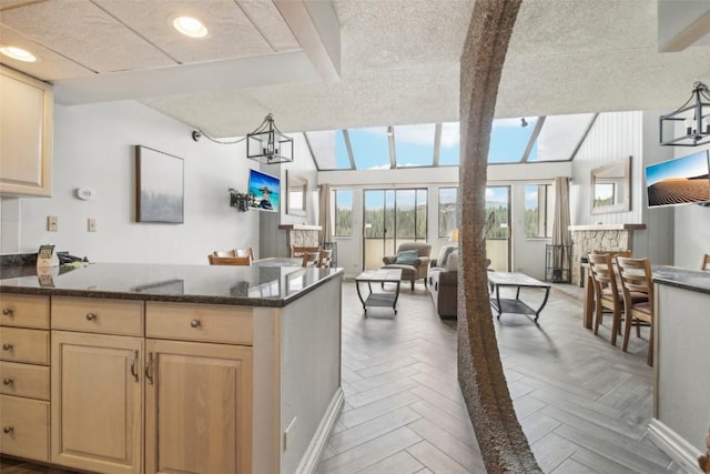 kitchen featuring lofted ceiling with beams, decorative light fixtures, and light parquet floors