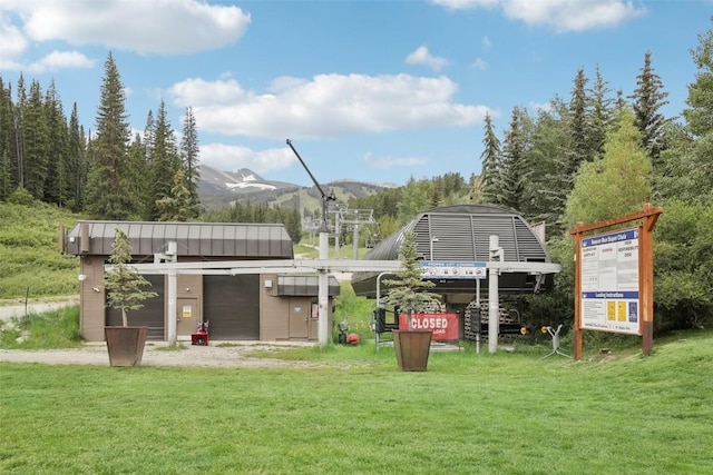 view of playground featuring a lawn and a mountain view