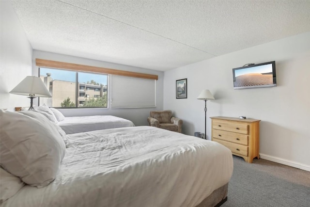 bedroom featuring carpet and a textured ceiling