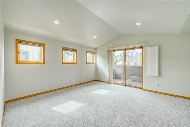 carpeted empty room featuring vaulted ceiling, recessed lighting, and baseboards