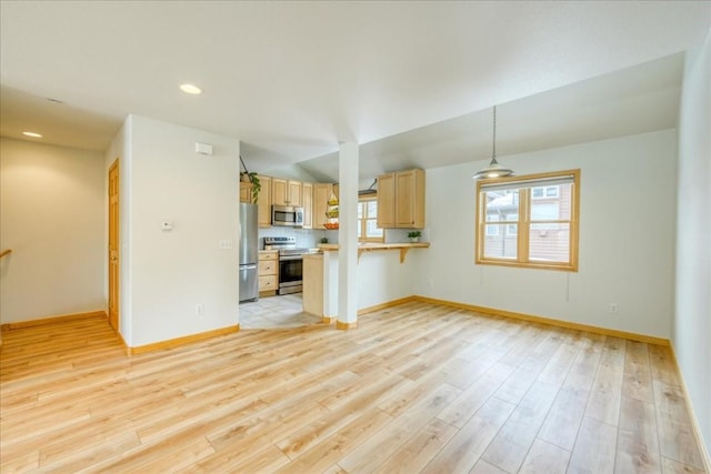 unfurnished living room with baseboards and light wood finished floors